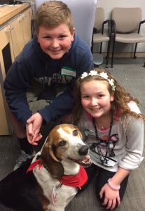 Children of Penn Medicine employees enjoying pet therapy as part of Take Your Kids to Work Day.