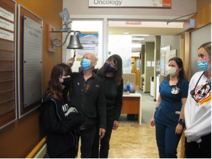 Dr. John Smelcer “ringing the bell” as his wife, daughter, and oncology nurses look on, Ellis Fishel Cancer Center, MU Health, Columbia, Missouri.